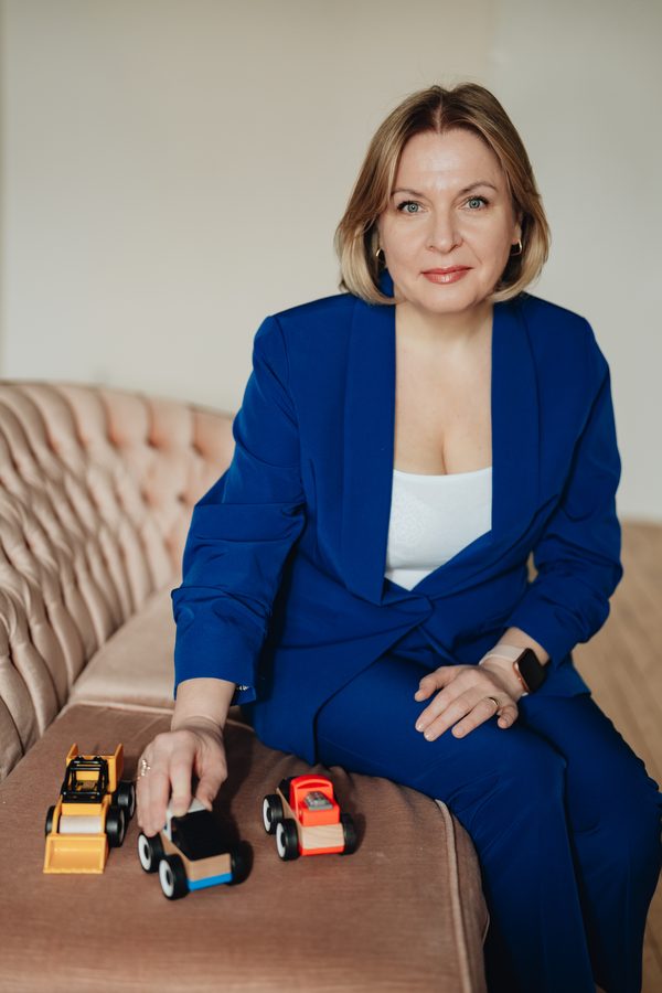Nadiia with wooden toy cars